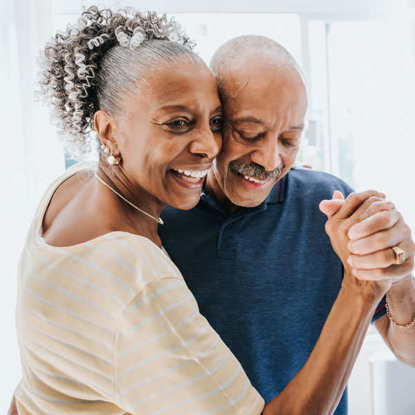 mature couple dancing and smiling