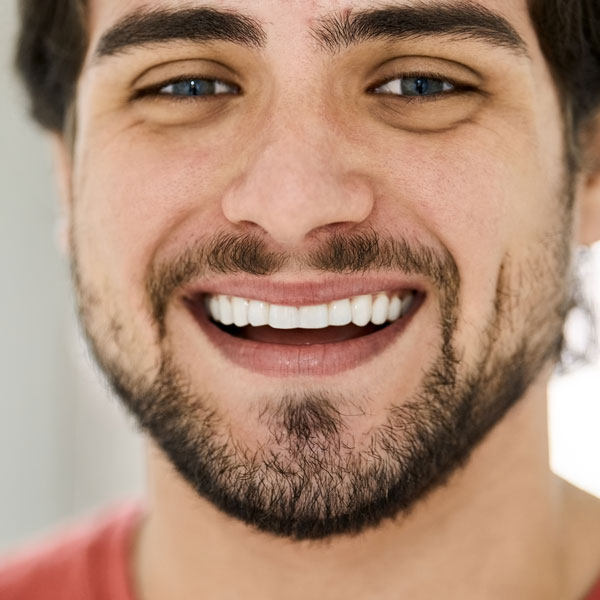 closeup of man smiling with nearly perfect teeth
