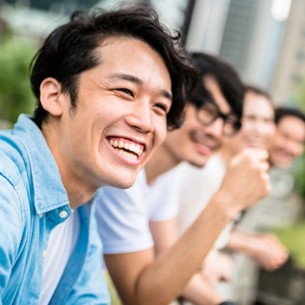 young adult male with friends laughing
