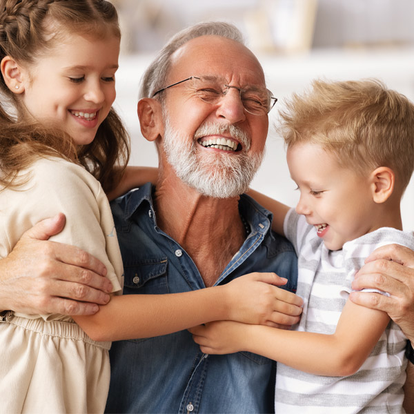 Mature man laughing with two grandkids