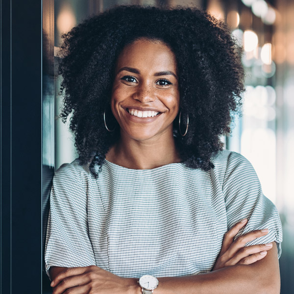 woman with arms crossed smiling