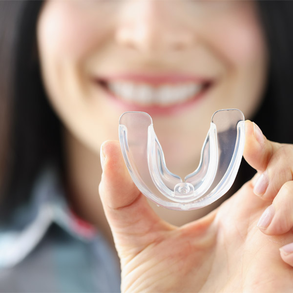 woman holding dental mouthguard